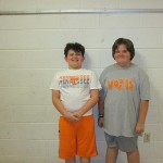 two 6th grade students wearing college colors